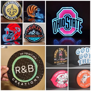 May include: A collection of illuminated signs featuring various sports team logos, including the New Orleans Saints, Cincinnati Reds, and Ohio State, alongside custom designs with text like R&B Creations and Finish The Fight in various shapes.