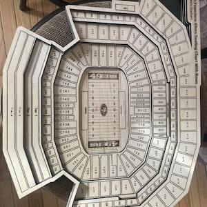 May include: Wooden seating chart of Levi's Stadium, home of the San Francisco 49ers, with rows and seat numbers. The chart includes the 49ers logo and the words "49ERS" and "VISITOR".