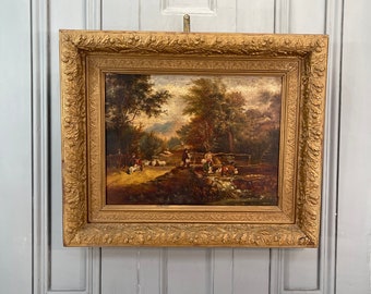 May include: A framed oil painting depicting a rural landscape with figures and sheep crossing a small bridge. The painting is set in a wooded area with a stream and a distant mountain range. The frame is ornate and gold in color.