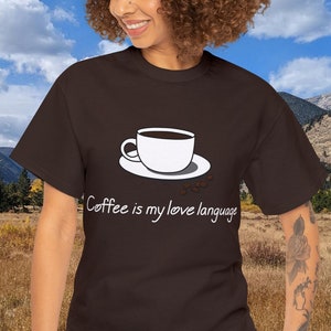 May include: A brown t-shirt with a white graphic of a coffee cup and the text "Coffee is my love language".