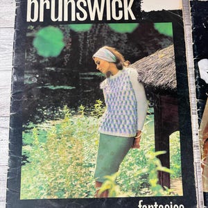 May include: Vintage "Brunswick" magazine cover featuring a woman in a knitted sweater and skirt. The cover has the word "Brunswick" in white, with the word "fantasies" below. The magazine is volume no. 655.