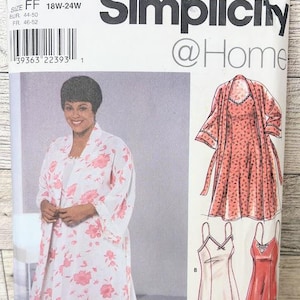 May include: Simplicity @Home sewing pattern 8486. The pattern features a woman wearing a white robe with pink floral designs. The pattern also includes a dress and a robe with a dotted pattern. Size 18W-24W.