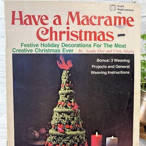 May include: A vintage book cover titled "Have a Macrame Christmas" featuring a macrame Christmas tree decorated with red berries and pink accents. The cover also includes text about festive holiday decorations and weaving instructions.