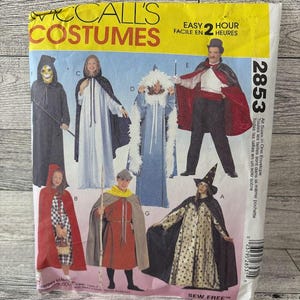 May include: A vintage McCall's sewing pattern for costumes. The pattern is for seven different costumes: a witch, a wizard, a fairy, a magician, a red riding hood, a medieval character, and a grim reaper. The pattern is labeled "Easy 2 Hour" and "Sew Free".