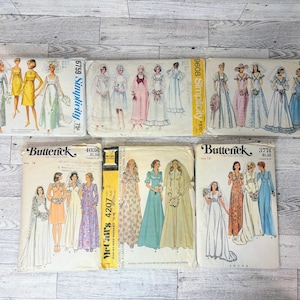May include: A collection of eight vintage sewing patterns featuring illustrations of various wedding and formal dresses. The envelopes include Simplicity patterns 6759, 9608, and 6399, along with Butterick patterns 4036, 3774, and a McCall's 4207 pattern.