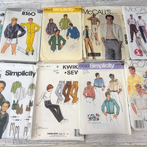 May include: A collection of vintage sewing patterns for men's clothing, including shirts, jackets, and pants. The patterns feature illustrations of the clothing designs and are from brands like Simplicity, McCall's, and Kwik Sew.