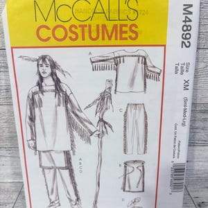 May include: A McCall's Costumes sewing pattern, M4892, featuring illustrations of a Native American costume. The pattern includes a shirt, pants, and accessories. The package is yellow and white with the text "McCall's Costumes". Size XM (Sml-Med-Lrg).
