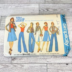 May include: Vintage Simplicity sewing pattern featuring illustrations of a shirt, top, reversible wrap skirt, pants, and scarf. The pattern includes the text "GO EVERYWHERE" and "STRETCH KNITS ONLY". The pattern is size 10.