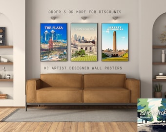 May include: Three framed wall posters featuring illustrations of Kansas City landmarks: The Plaza, Union Station, and the Liberty Memorial. The posters are displayed on a wall above a brown leather couch. The text "ORDER 3 OR MORE FOR DISCOUNTS" and "KC ARTIST DESIGNED WALL POSTERS" are visible below the posters.
