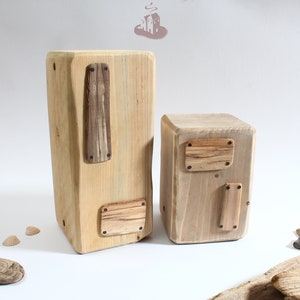 May include: Two wooden boxes with different sizes and shapes. Both boxes have a rustic look and are made of reclaimed wood. The boxes have a natural wood finish and are decorated with small pieces of wood.