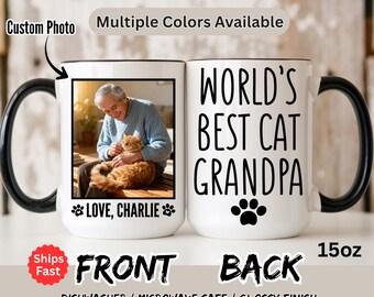 May include: A white ceramic mug with a black handle and rim. The front features a photo of a man with a cat and the text "LOVE, CHARLIE". The back says "WORLD'S BEST CAT GRANDPA" with a paw print. The mug holds 15oz.