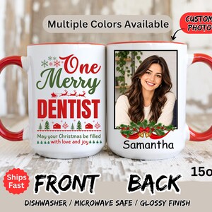 May include: A white ceramic mug with a red handle and rim, featuring a 15oz capacity. The front displays the text One Merry DENTIST with Christmas graphics. The back shows a custom photo area above the name Samantha and holiday greenery.