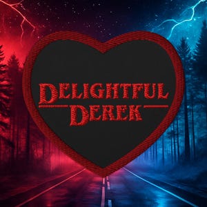May include: A heart-shaped patch with the words "DELIGHTFUL DEREK" embroidered in red on a black background. The patch has a red border. The background shows a road through a forest with red and blue lighting.