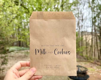 May include: A brown paper bag with the text "Better Together Like Milk and Cookies" and the names "Rachel & Mike" and the date "06.12.2025" printed on it.