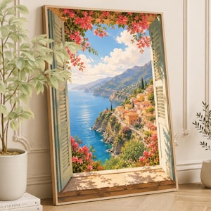 Peut inclure: Une impression d'art encadrée rectangulaire représentant une vue par une fenêtre ouverte sur une ville côtière méditerranéenne avec des bâtiments orange sur une falaise, une mer bleue et des fleurs de bougainvillier rose vif.