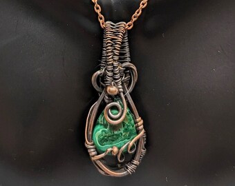 May include: A copper wire wrapped pendant necklace featuring a green malachite stone.