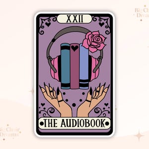 May include: A tarot card with a purple background and a black border. The card is titled "The Audiobook" and features a pair of headphones with a stack of books inside. The card number, "XXII", is in the top left corner.