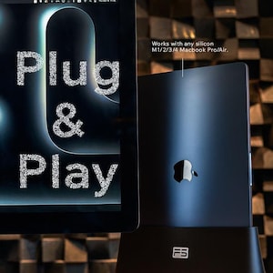 May include: A black laptop stand with a built-in MagSafe 3 cable and two Thunderbolt 4 connectors. The stand is designed to work with any silicon M1/2/3/4 Macbook Pro/Air. The stand has a strong body and a great design, making it look amazing on a desk.