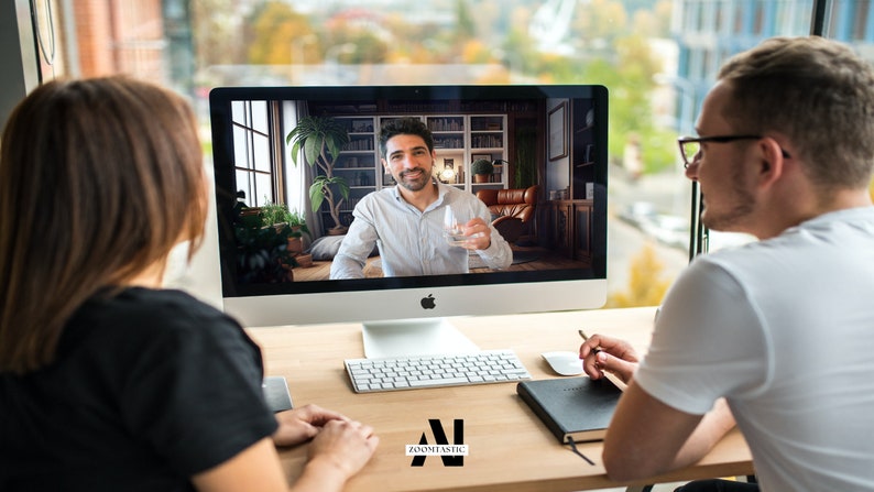 May include: Two people are having a video call on a computer. The person on the screen is holding a glass of water. The people are sitting at a desk with a keyboard, a notebook, and a pen.