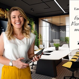 May include: A woman smiles while holding a tablet in a modern office setting. The office features a green wall, a large conference table, and yellow chairs. The text on the white sign reads "Easy to use! For Zoom, Microsoft Teams and more... Zoomnetic"