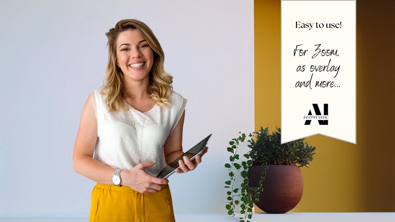 May include: A woman smiles while holding a tablet in front of a white and yellow wall. The wall has a white sign with the text "Easy to use! For Zoom, as overlay and more... Zoomnetic".