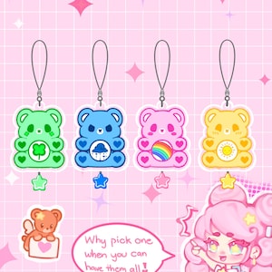 May include: Four colourful bear-shaped charms with silver loops. The charms are green with a four-leaf clover, blue with a rain cloud, pink with a rainbow, and yellow with a sun. A small bear with wings and a heart is also shown.