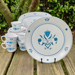May include: A set of blue and white floral patterned dinnerware. The set includes plates, bowls, and cups. The dinnerware is made of a durable material and is perfect for everyday use.