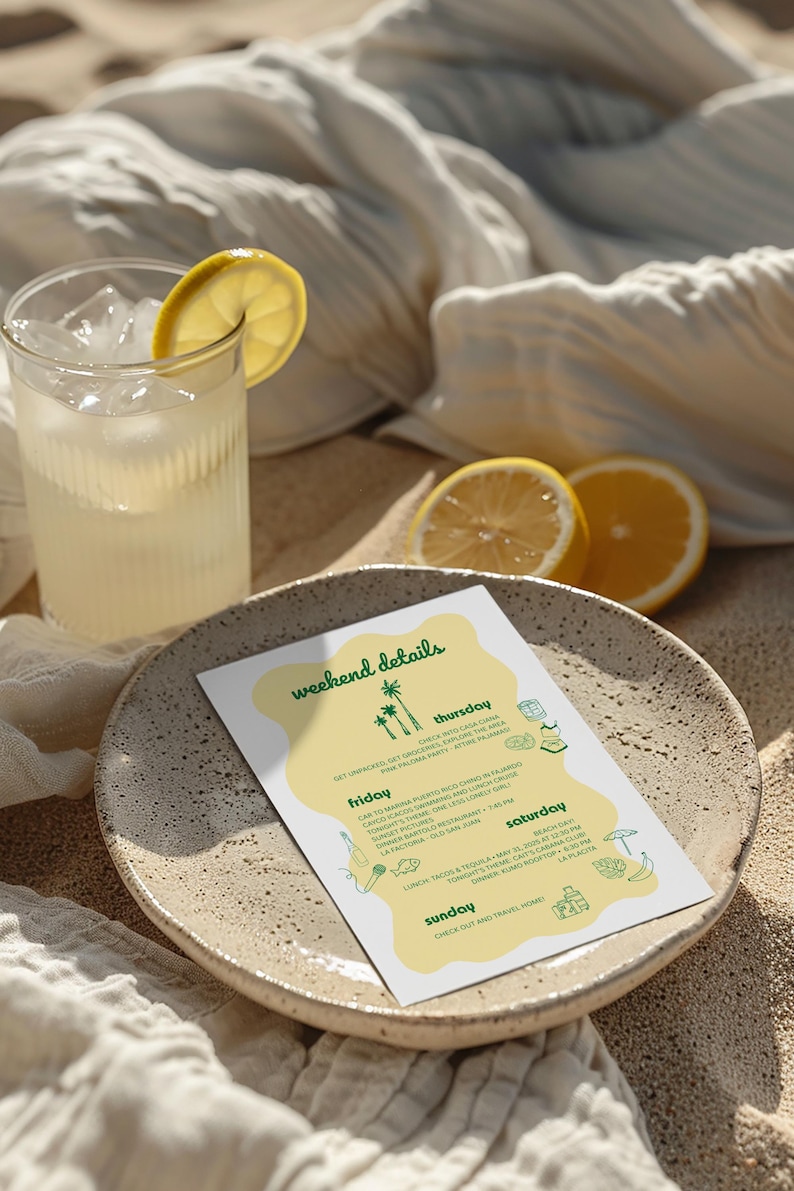 May include: A refreshing drink with ice and a lemon slice sits next to a plate with a weekend details itinerary. The plate is on a sandy surface, with a white cloth and lemon halves in the background. The itinerary lists activities.