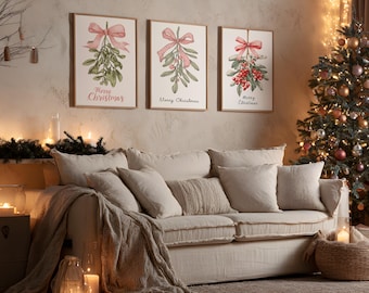 May include: Three framed botanical prints with mistletoe and bows, reading "Merry Christmas." A beige sofa with throw pillows and a blanket sits in front of the prints. A Christmas tree with ornaments and lights is in the background.
