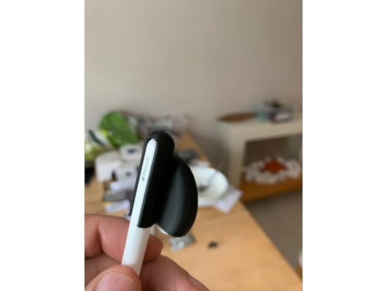 May include: A white stylus with a black silicone grip. The grip has a small, black, round, silicone tip.