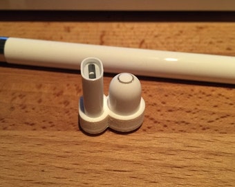 May include: White plastic replacement tips for a stylus pen. The tips have a small hole in the center.