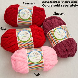 May include: Four skeins of yarn in different colors: red, crimson, maroon, and pink. Each skein has a label that says "Spirit Yarn" and "Show Your Colors!"