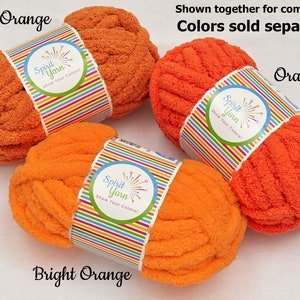 May include: Three skeins of yarn in different shades of orange. The yarn is called "Spirit Yarn" and the colors are "Burnt Orange", "Orange", and "Bright Orange".