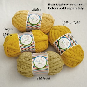 May include: Four skeins of yarn in different shades of yellow. The yarn is labeled "Spirit Yarn" and the colors are "Maize", "Bright Yellow", "Yellow Gold", and "Old Gold".
