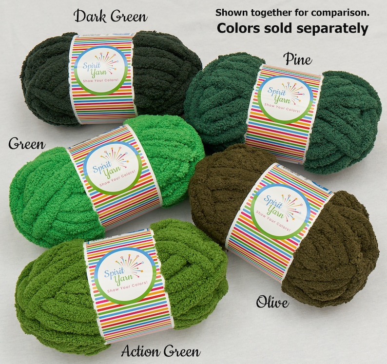 May include: Five skeins of Spirit Yarn in different shades of green. The colors are Dark Green, Pine, Green, Action Green, and Olive. The yarn is a chunky, fuzzy texture. The label on each skein says "Spirit Yarn Show Your Colors!"