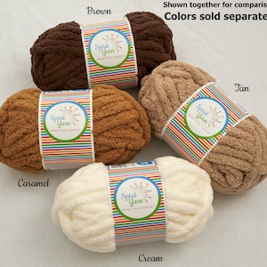 May include: Four skeins of Spirit Yarn in different colors: brown, caramel, cream, and tan. Each skein has a label with the Spirit Yarn logo and the text "Show Your Colors!"