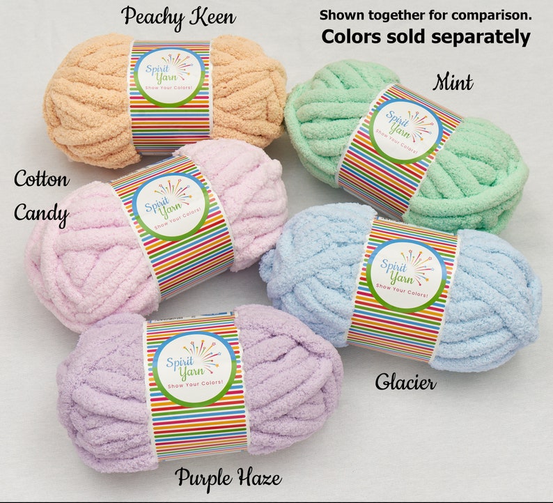 May include: Five skeins of soft, chunky yarn in various pastel colors: peach, pink, light blue, lavender, and mint. Each skein has a label that reads "Spirit Yarn Show Your Colors!" The colors are labeled "Peachy Keen", "Cotton Candy", "Glacier", "Purple Haze", and "Mint".
