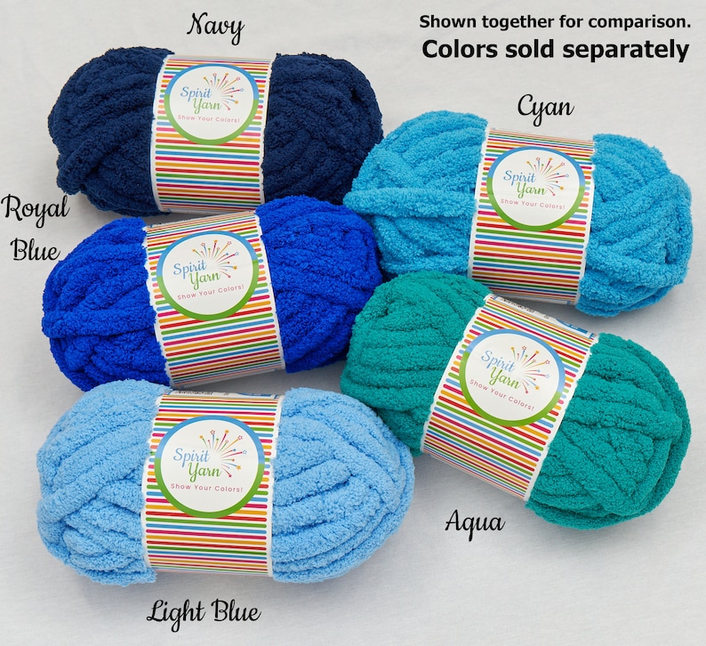May include: Five skeins of Spirit Yarn in various shades of blue, including navy, royal blue, light blue, cyan, and aqua. Each skein has a colorful label with the words "Spirit Yarn" and "Show Your Colors!"