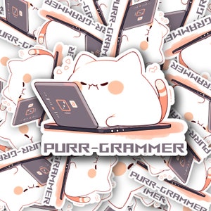 May include: A white cat with orange ears and a tail is sitting in front of a laptop computer. The laptop screen shows a design program with a fire icon. The cat has an angry expression on its face. The text "PURR-GRAMMER" is written in black letters on a pink background.