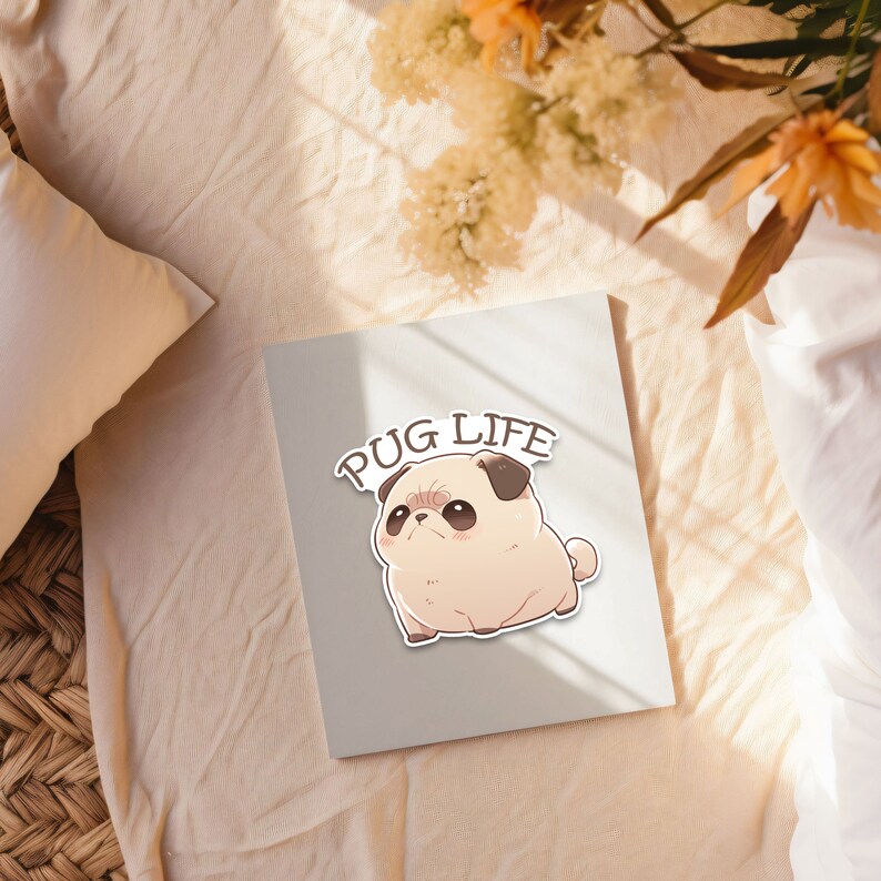 May include: A white card with the text "PUG LIFE" in black letters. A cartoon pug with brown eyes and a black nose is printed on the card.