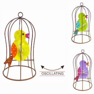 May include: Three metal birdcage clocks with colorful birds inside. The birds are yellow, green, and purple. The clocks are oscillating.