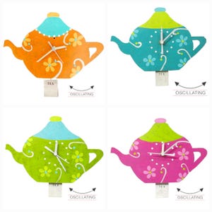 May include: Four colourful teapot-shaped wall clocks with a white face and black hands. Each clock has a different colour: orange, teal, green, and pink. The clocks are all decorated with a floral pattern and the word "TEA" is written on the bottom of each clock.