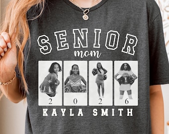 May include: Dark gray t-shirt with the words "SENIOR mom" in white block letters. Below the text are four small black and white photos of a cheerleader. The name "KAYLA SMITH" is printed below the photos.