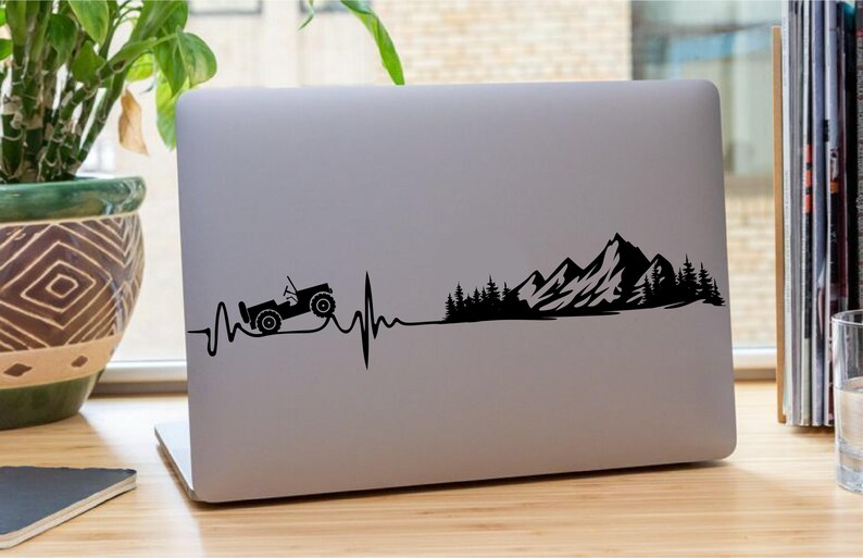 May include: Black and white silhouette of a jeep driving over a mountain range with a heartbeat line. The mountains are in the background and the jeep is in the foreground.