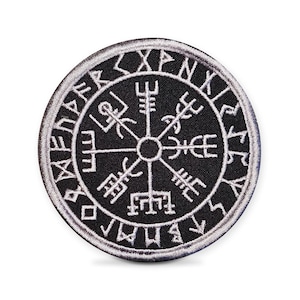 May include: Circular black patch featuring a white embroidered Vegvisir symbol, a Viking compass. The symbol is surrounded by white runes. The patch has a white border, suitable for clothing or accessories.