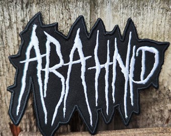 May include: Black embroidered patch with the word "ABATHUR" in white lettering. The letters are stylized with jagged edges.