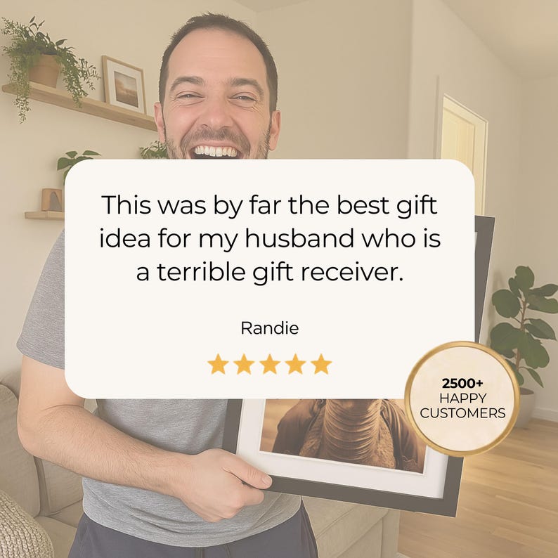May include: A framed photograph held by a smiling person. The frame is black with a white mat. Text on a cream-colored background reads: "This was by far the best gift idea for my husband who is a terrible gift receiver." Also, "2500+ HAPPY CUSTOMERS."