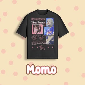 May include: Black t-shirt featuring a graphic design with the text "Hirai Momo" and images of a performer. The design includes pink accents, the group's logo, and a signature. The word "Momo" is displayed at the bottom.
