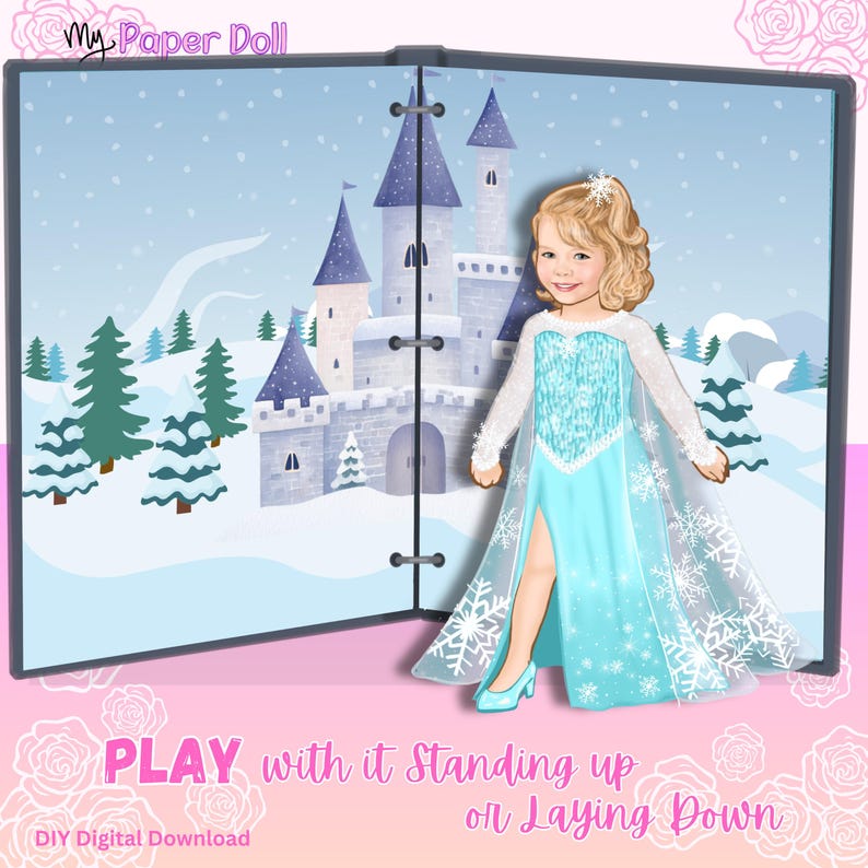 May include: A My Paper Doll digital download featuring a blonde paper doll wearing a light blue gown with snowflake patterns and a sheer cape. The background shows a winter castle scene with snow-covered trees. Text reads My Paper Doll and PLAY.