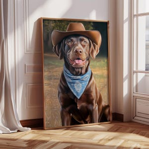 May include: A brown Labrador Retriever wearing a brown cowboy hat and a blue bandana. The dog is sitting in a grassy field and looking up.